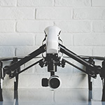 Black and white image of a drone sat on table