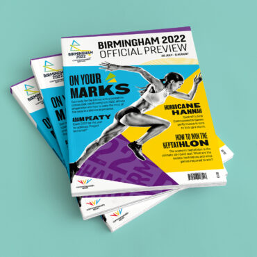 Mockup showing three Birmingham 2022 Preview Magazines piled on top of each other.
