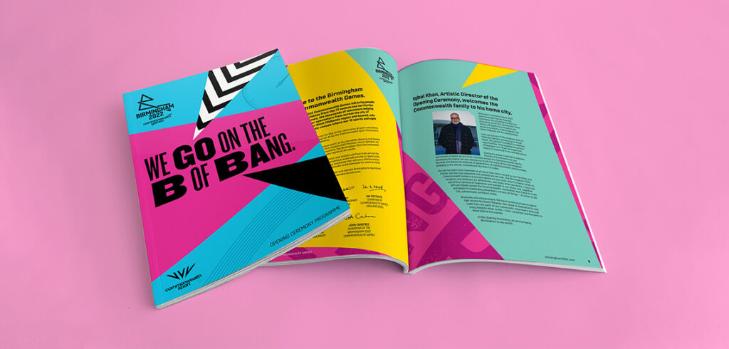 Mockup of the opening ceremony programme shows the front cover featuring the headline "We go on the B of Bang", with a one spread of the magazine open underneath it.