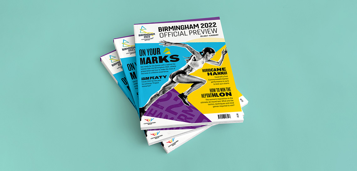 Birmingham 2022 Commonwealth GAmes preview magazines shown in a pile of three. The front cover features Katarina Johnson-Thompson and headlines "On your Marks", "Adam Peaty", "Hurricane Hannah", and "How to Win the Heptathlon" feature on a bright and colourful background.
