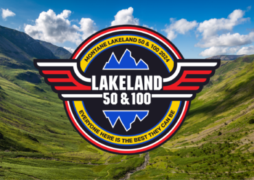 Image shows the Lakeland 2024 logo over a landscape photograph of the Lake District/ The logo has the text Lakeland 50 & 100 in the centre of a circle. Coming out from the logo are a pair of wings. Arond the circle is written: Montane Lakeland 50 & 100 2024, everyone here is the best they can be.