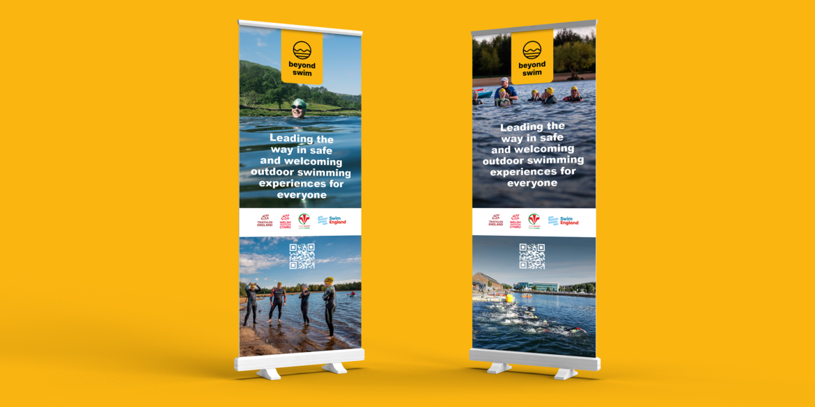 Two Beyond Swim roller banners promoting safe and welcoming outdoor swimming experiences, designed as part of open-water swimming venue design guidance.