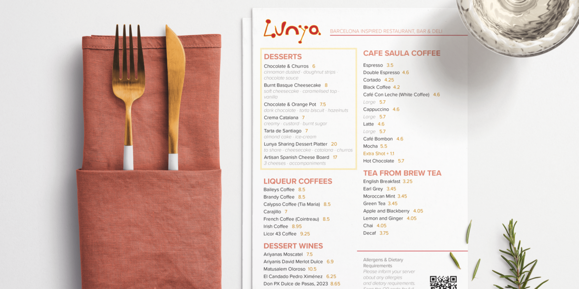 Lunya Restaurant Menu Design – Desserts, liqueur coffees, dessert wines and hot drinks menu styled alongside gold cutlery in a terracotta linen napkin, a water glass and a sprig of rosemary on a neutral background.
