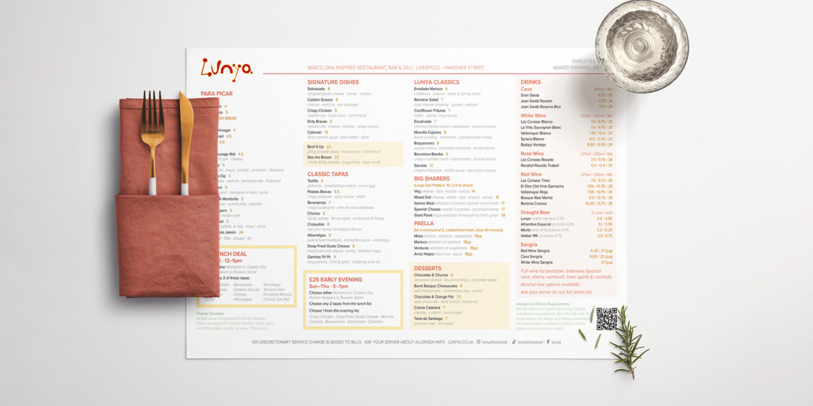 Lunya Restaurant Menu Design – Full food and drinks menu displayed alongside gold cutlery in a terracotta linen napkin, a water glass and fresh herbs, covering tapas, signature dishes, paella, wines and more at Lunya Liverpool, Hanover Street.